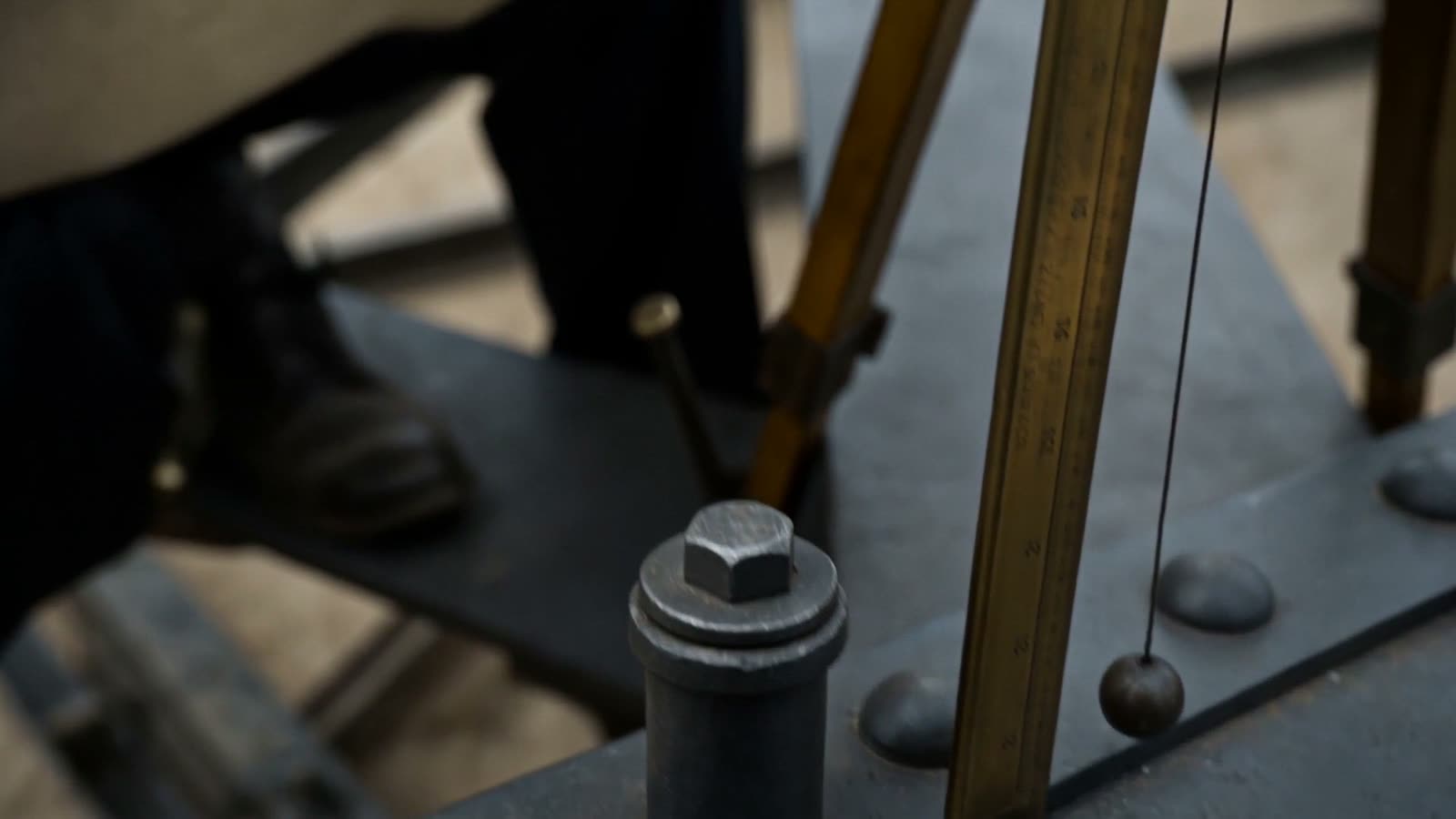 A plumb-line and jack instrument on the ironwork, close up