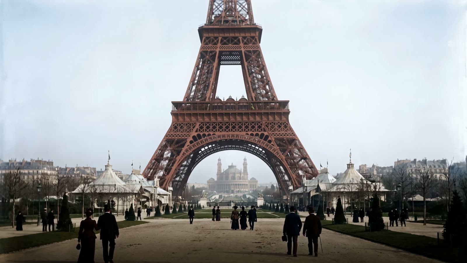 The Eiffel Tower in its original venetian red above the crowds of the 1889 Exposition, the Trocadéro beyond
