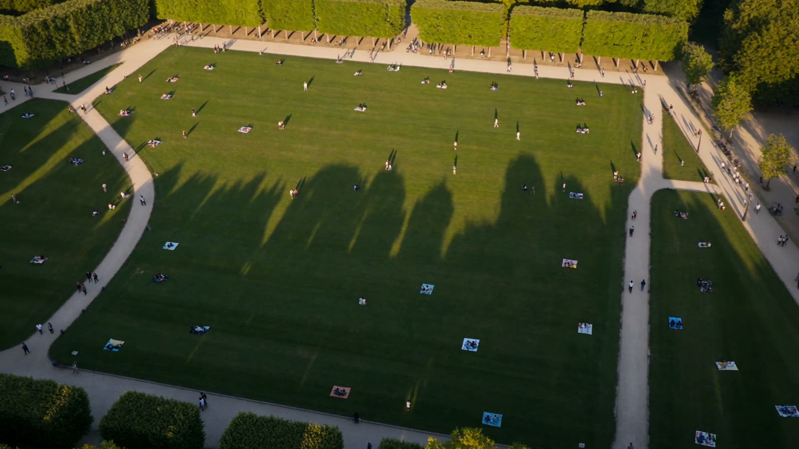 Overhead view of the modern Champ de Mars lawns, long shadows