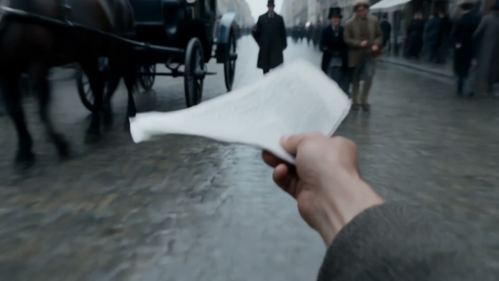 A hand holding a printed sheet on a Paris street, carriages beyond